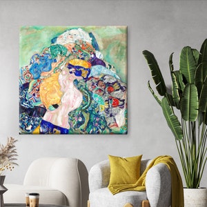 May include: Square canvas art print featuring a colorful, abstract painting. The artwork showcases a woman's profile with a cascade of vibrant colors, including blues, greens, yellows, and pinks. The painting is displayed on a wall above a modern gray armchair.