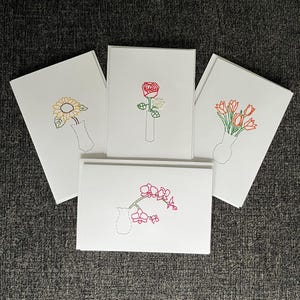 Handgeborduurde bloemenkaarten
