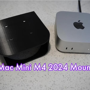 May include: A black 3D printed stand for a Mac Mini M4 2024 computer. The stand has four holes on the top and a cutout on the bottom. The stand is next to a silver Mac Mini M4 2024 computer.