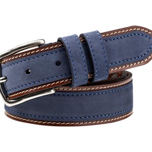 May include: A blue suede belt with a silver buckle. The belt has brown leather trim and white stitching. A classic accessory for trousers or jeans.