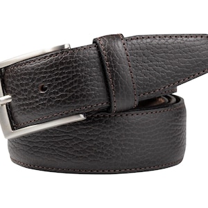May include: A dark brown leather belt with a textured surface and a silver-colored buckle. The belt has a classic design with a rectangular buckle and a stitched edge. A stylish accessory for any wardrobe.