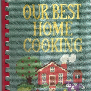 May include: A vintage cookbook with a blue and green cover featuring a red house with a white picket fence and the text "Our Best Home Cooking". The bottom of the cover reads "PHP - Health Centre East Sunshine Fund".