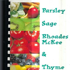 May include: A cookbook titled "Parsley Sage Rhoades McKee & Thyme" featuring a variety of fresh vegetables and herbs, including tomatoes, kiwi, peppers, peas, and garlic.