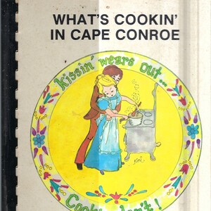 May include: A vintage cookbook cover with a yellow and red illustration of a couple cooking in a kitchen. The text on the cover reads "What's Cookin' in Cape Conroe" and "Kissin' wears out... Cookin' don't!"  The cookbook is from the Cape Conroe Ladies Society in Montgomery, Texas.