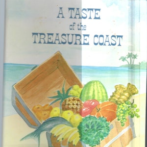 May include: A Taste of the Treasure Coast cookbook cover with a watercolor illustration of a wooden crate overflowing with fresh fruit, vegetables, and a fish. The crate is on a sandy beach with a blue ocean and palm trees in the background.