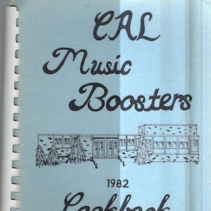 May include: A blue cover with the text "CAL Music Boosters 1982 Cookbook" in black cursive font. A black and white illustration of a school building with trees is in the center of the cover.