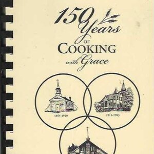 May include: A black and white image of a cookbook titled "150 Years of Cooking with Grace". The cover features three overlapping circles with illustrations of the church building from different eras. The text "Trinity Evangelical Lutheran Church Caledonia, Wisconsin 1855-2005" is also included.