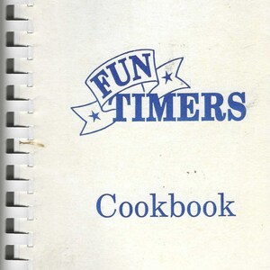 May include: A spiral-bound cookbook titled "Fun Timers Cookbook." The cover is white with blue text and a checkered pattern at the top and bottom. The title is in a stylized font with a banner design.