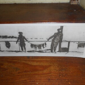 May include: Black and white etching of two figures standing on a dock, holding a string of fish. The sign in the background reads "Santa Fe Fish".