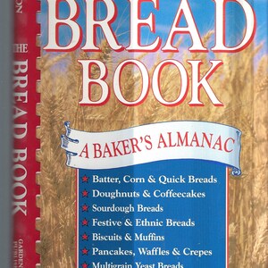 May include: The Bread Book: A Baker's Almanac by Ellen Foscue Johnson. A blue and white book cover with a red title and a red and white illustration of wheat stalks. The book cover lists different types of bread recipes, including batter, corn, quick breads, doughnuts, coffee cakes, sourdough breads, festive and ethnic breads, biscuits, muffins, pancakes, waffles, crepes, and multigrain yeast breads.