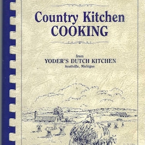 May include: A vintage cookbook titled "Country Kitchen COOKING" from Yoder's Dutch Kitchen in Scottville, Michigan. The cover features a blue spiral binding and a black and white illustration of a rural landscape with hay bales.