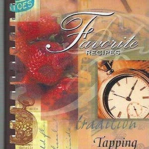 May include: A spiral-bound recipe book with the title "Favorite Recipes" in elegant script. The cover features a collage of images, including strawberries, a pocket watch, and the text "Tapping into Taste."