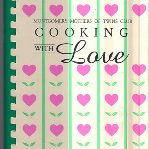 May include: A vintage cookbook with a white cover and green and pink stripes. The title is "Cooking with Love" and the subtitle is "Montgomery Mothers of Twins Club".