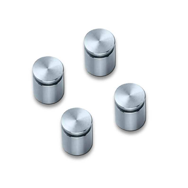 May include: Four silver metal sign holders with a round top and a cylindrical base.