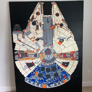 May include: A black and white illustration of the Millennium Falcon spaceship, a popular spacecraft from the Star Wars franchise. The illustration is divided into 12 sections, each with a different detail of the ship's interior. The ship is depicted in a top-down view, showing its cockpit, engine, and other features.