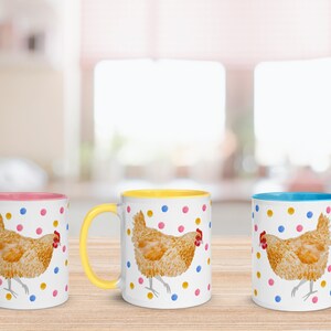 May include: Three ceramic mugs with a white background and a colorful rim. Each mug features a watercolor illustration of a brown chicken with yellow, pink, and blue polka dots.
