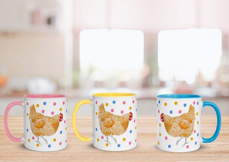 May include: Three ceramic mugs with a white background and a colorful rim. Each mug features a watercolor illustration of a brown chicken with yellow, pink, and blue polka dots.