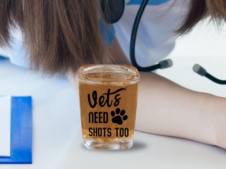 A large 2.2 ounce sized square shot glass that says in a permanent vinyl material, the lettering says, Vets Need Shots Too on the front side of the glass in your choice of colors. The lettering is smooth and will stay on without fading.
