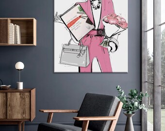 May include: A woman in a pink suit and sunglasses is holding a book titled "How to Find a Get Paid What You're Worth" and a bouquet of pink flowers. She is carrying a grey handbag.