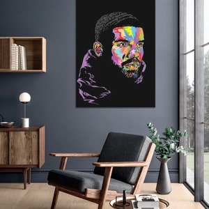 May include: A colorful pop art portrait of a man with a black background. The man is wearing a purple hooded sweatshirt and has a colorful face.