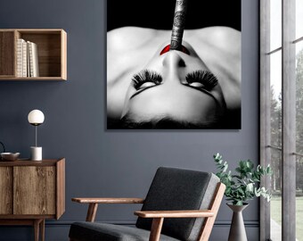 May include: Black and white photo of a woman with red lips, holding a dollar bill in her mouth, with smoke coming from the end of the bill.