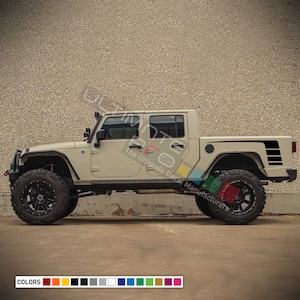 May include: A tan Jeep truck with black side stripes and black wheels. The truck is parked in front of a tan brick wall. The image includes the text "The Ultimate Decal Manufacturer's".