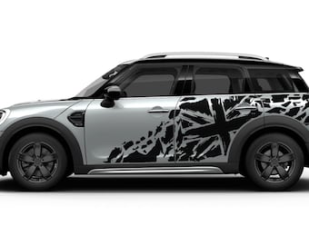 May include: A silver Mini Cooper Countryman with a black and white distressed Union Jack graphic decal on the side.