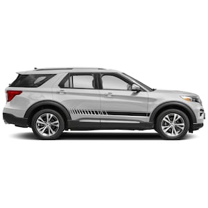 Op de afbeelding: Een witte Ford Explorer SUV met zwarte zijstrepen. Het voertuig wordt in zijaanzicht getoond.