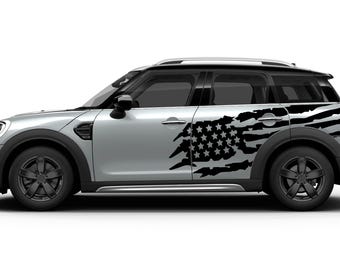 May include: A silver Mini Cooper Countryman with a black and white distressed American flag decal on the side.
