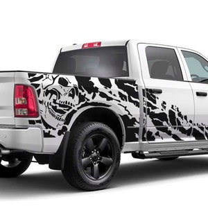 May include: White pickup truck with a black skull and camouflage graphic decal on the side.