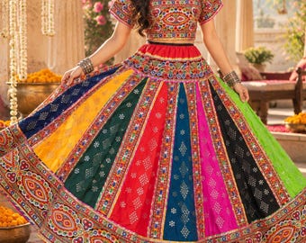 May include: A two-piece lehenga set featuring a short-sleeved blouse and a floor-length skirt. The garment is crafted from multi-colored panels in yellow, green, red, blue, pink, and black, decorated with intricate embroidery and mirror work.