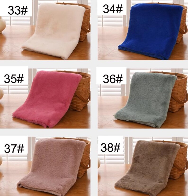 May include: Six different colors of faux fur fabric swatches, labeled with numbers 33, 34, 35, 36, 37, and 38. The swatches are displayed on a wooden surface.