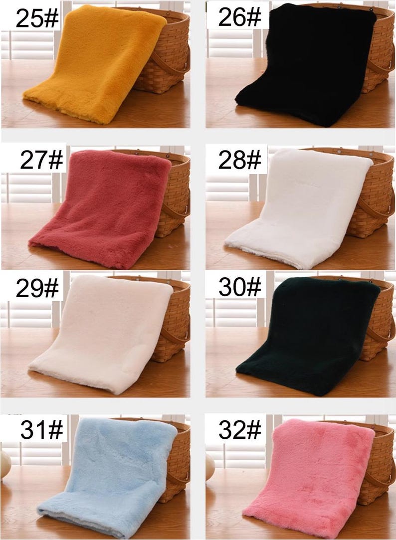 May include: Six different colors of faux fur fabric swatches displayed on a wooden table. The swatches are labeled with numbers 25 through 32.