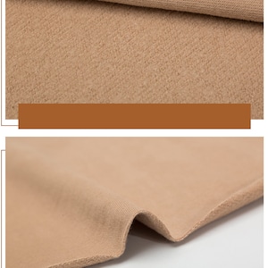 May include: Close-up of a light brown fabric with a soft, fuzzy texture. The fabric is folded over itself, showing the inside and outside of the material.