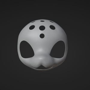 May include: A white mask with black eye holes and a pattern of black dots on the top. The mask has a slightly curved shape and a small mouth opening.