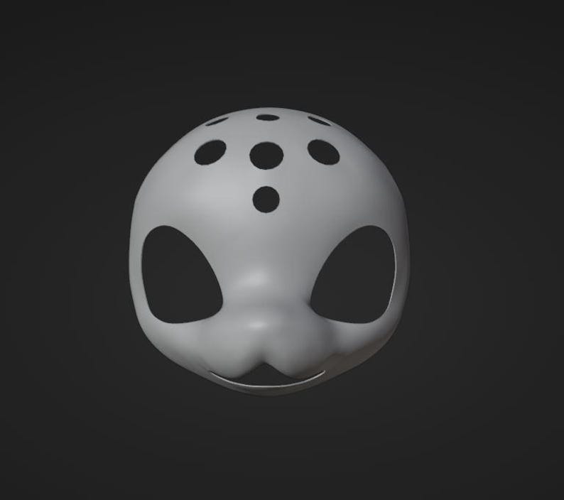 May include: A white mask with black eye holes and a pattern of black dots on the top. The mask has a slightly curved shape and a small mouth opening.