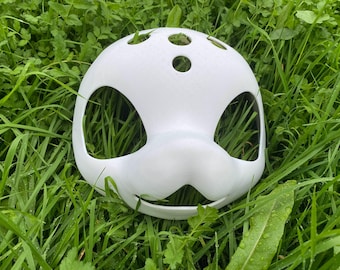 May include: White plastic mask with large eye holes and a small mouth hole. The mask has several small holes on the top.