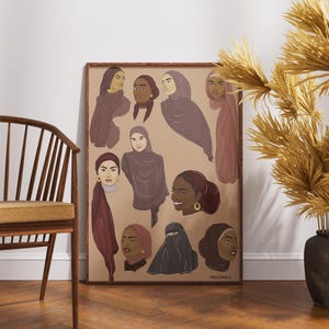 May include: A framed art print featuring illustrations of women wearing hijabs and headscarves in various styles. The artwork uses a muted color palette of browns, purples, and tans. The print is displayed on a wall next to a wooden chair and decorative vase.