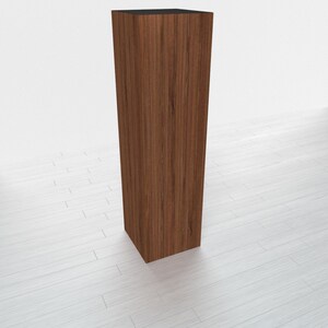 May include: A tall, rectangular wooden pedestal with a dark brown wood grain finish.