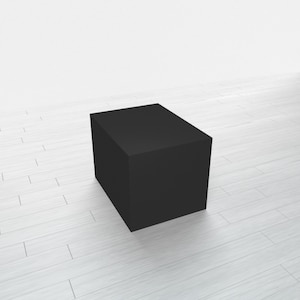 May include: A black square box sits on a white wood floor.