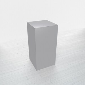 May include: A gray square pedestal or platform, possibly made of wood or plastic, sits on a white wood floor.