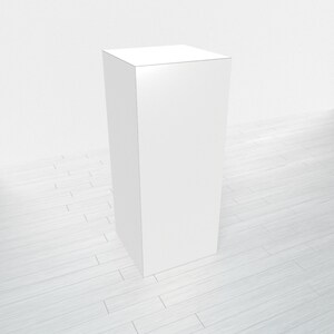 May include: A white, square pedestal or display stand, with a smooth surface, sits on a light wood floor.