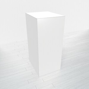 May include: A white, rectangular display stand with a smooth surface. The stand is on a light wood floor.