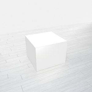 May include: A white square pedestal or platform on a light wood floor. The pedestal is a blank surface for displaying products.