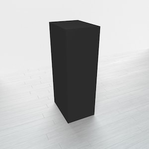 May include: A black rectangular pedestal or display stand. The stand is made of a smooth, solid material and has a simple, modern design.