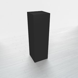 May include: A tall, black, rectangular pedestal or display stand. The stand is made of a smooth, solid material and has a simple, modern design.