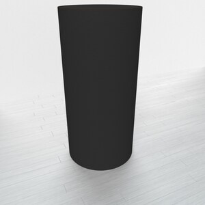 May include: A black cylindrical pedestal, standing on a white wood floor.