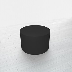 May include: A black cylindrical pedestal or platform, likely used for displaying products or merchandise.