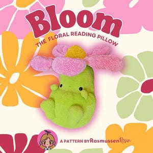 May include: A green floral reading pillow with a pink and yellow flower design. The word "Bloom" is in large pink letters above the text "The Floral Reading Pillow". The background features floral illustrations.