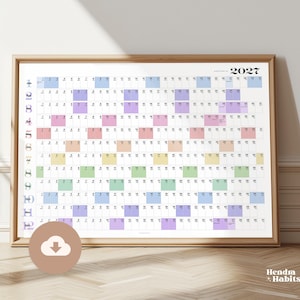 May include: A framed 2027 calendar for Australia, with a minimalist design. The calendar features a grid layout with each month and day clearly marked. The days are color-coded, and the frame is a light wood colour.